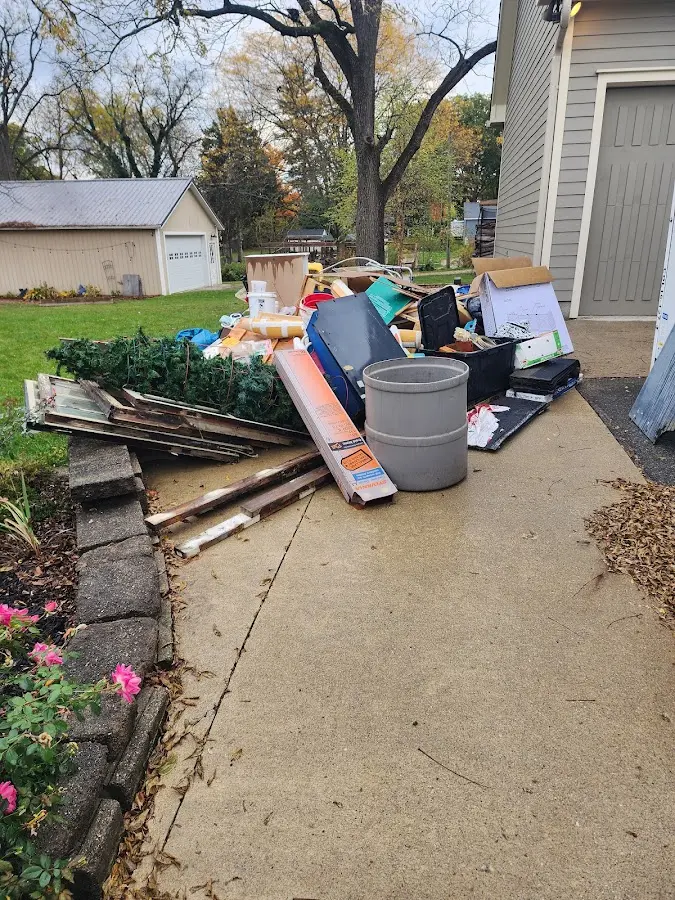 Dumpster being loaded with debris for 12 Yard Dumpster Rental in Fargo